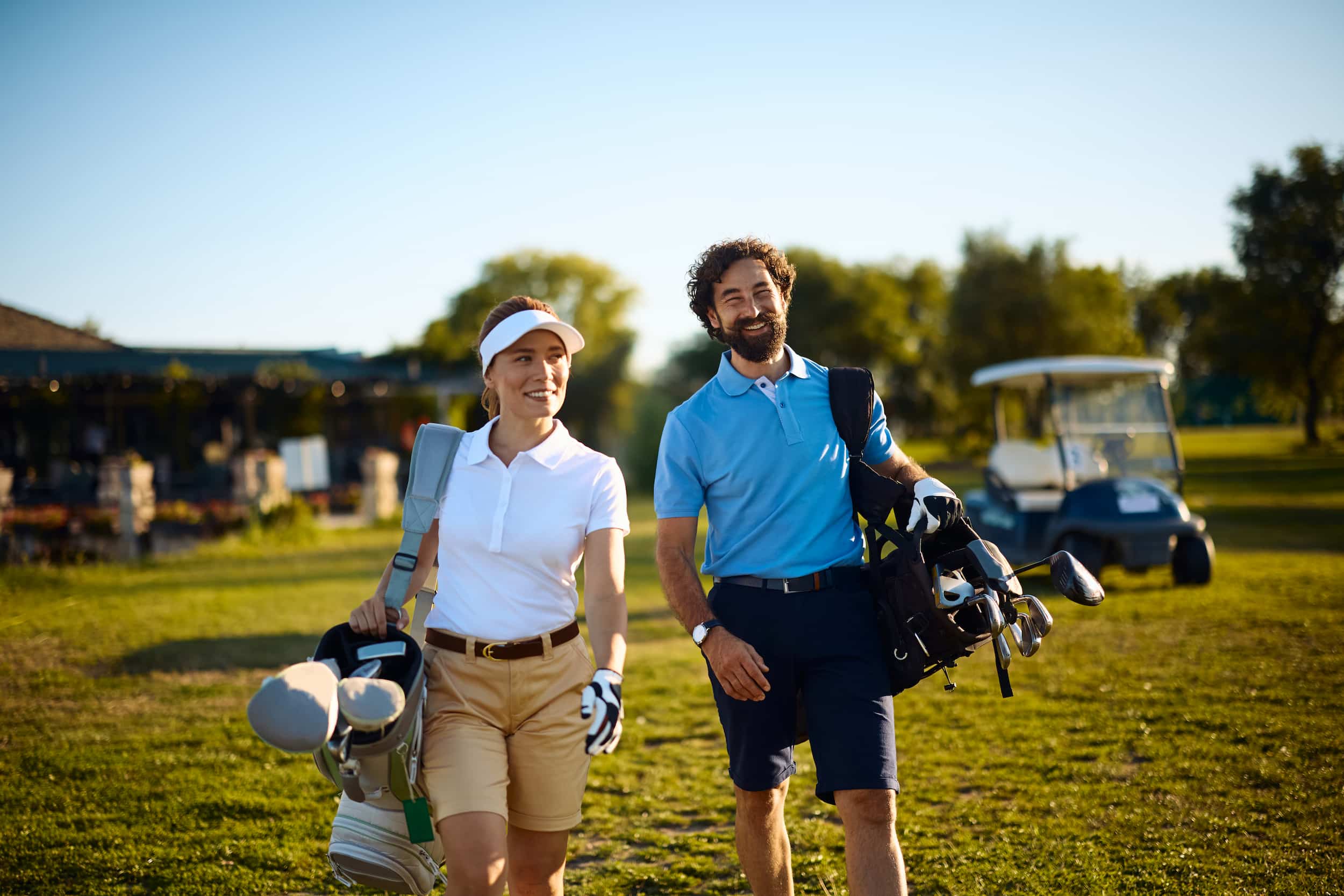 Two golfers walking a fairway